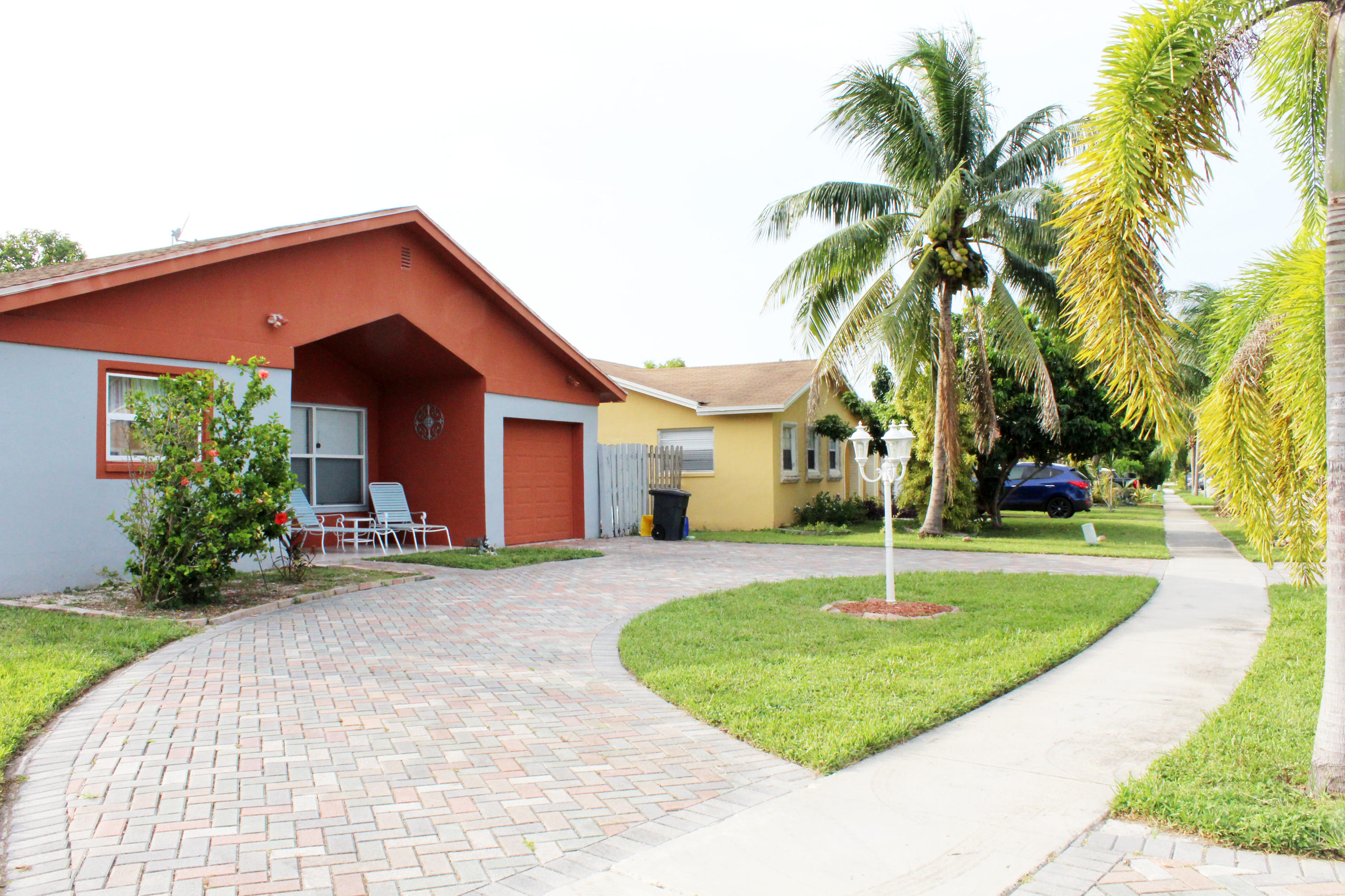 22787 Southwest 65th Way Boca Raton, FL 33428 - Photo 2 of 18 a view of a house with a yard and palm trees