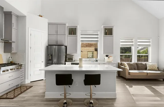 a kitchen with a sink stove top oven and refrigerator