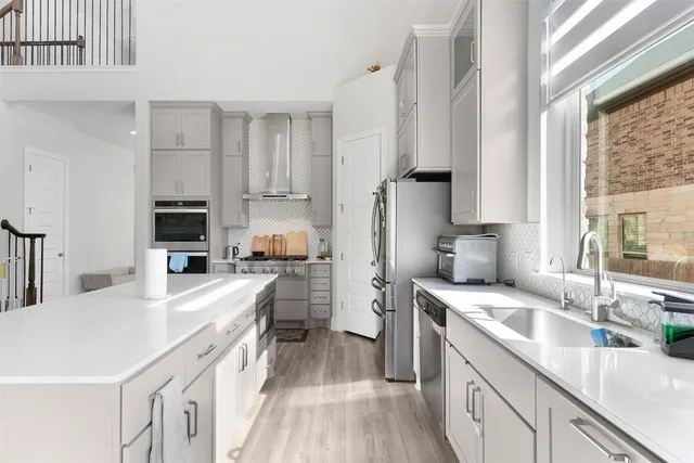 a kitchen with stainless steel appliances granite countertop a stove and a refrigerator