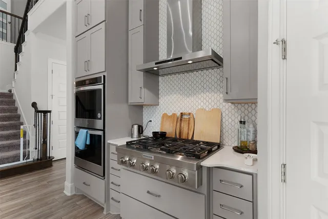 a kitchen with stainless steel appliances stove microwave and refrigerator