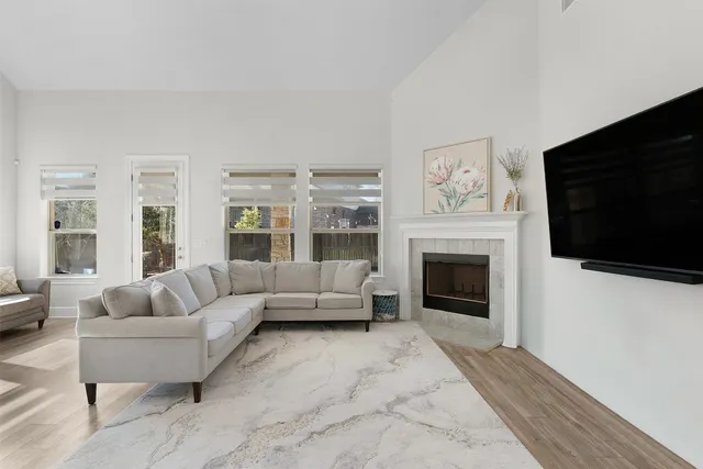 a bedroom with a bed couches and window