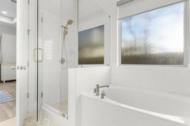 a view of a hallway with closet and a bathroom