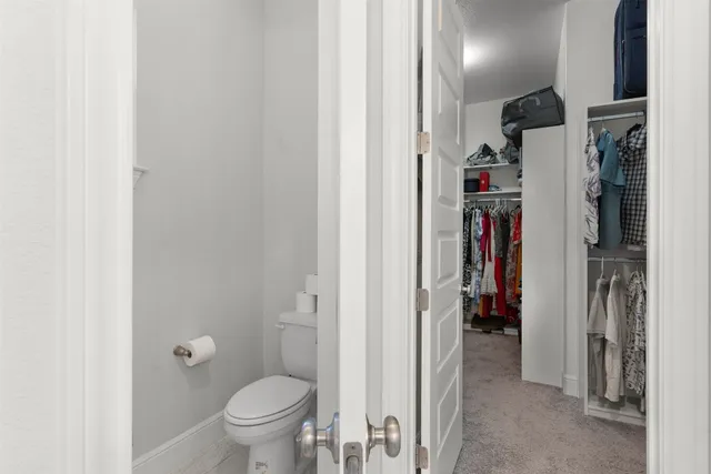 a view of a hallway with wooden floor and entryway