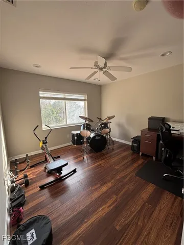 a view of a workspace with furniture and a gym cycle