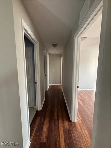 a view of hallway with wooden floor