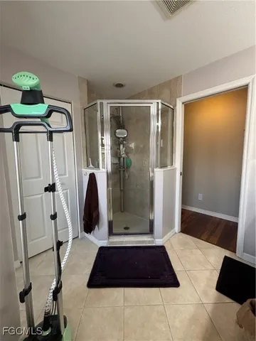a bathroom with a glass shower door