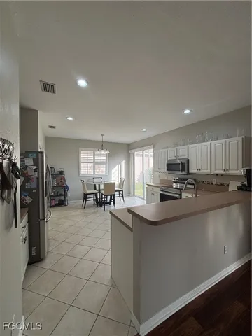 a kitchen with stainless steel appliances granite countertop a sink a stove and cabinets