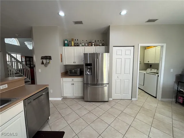 a kitchen with a refrigerator a stove top oven and a sink