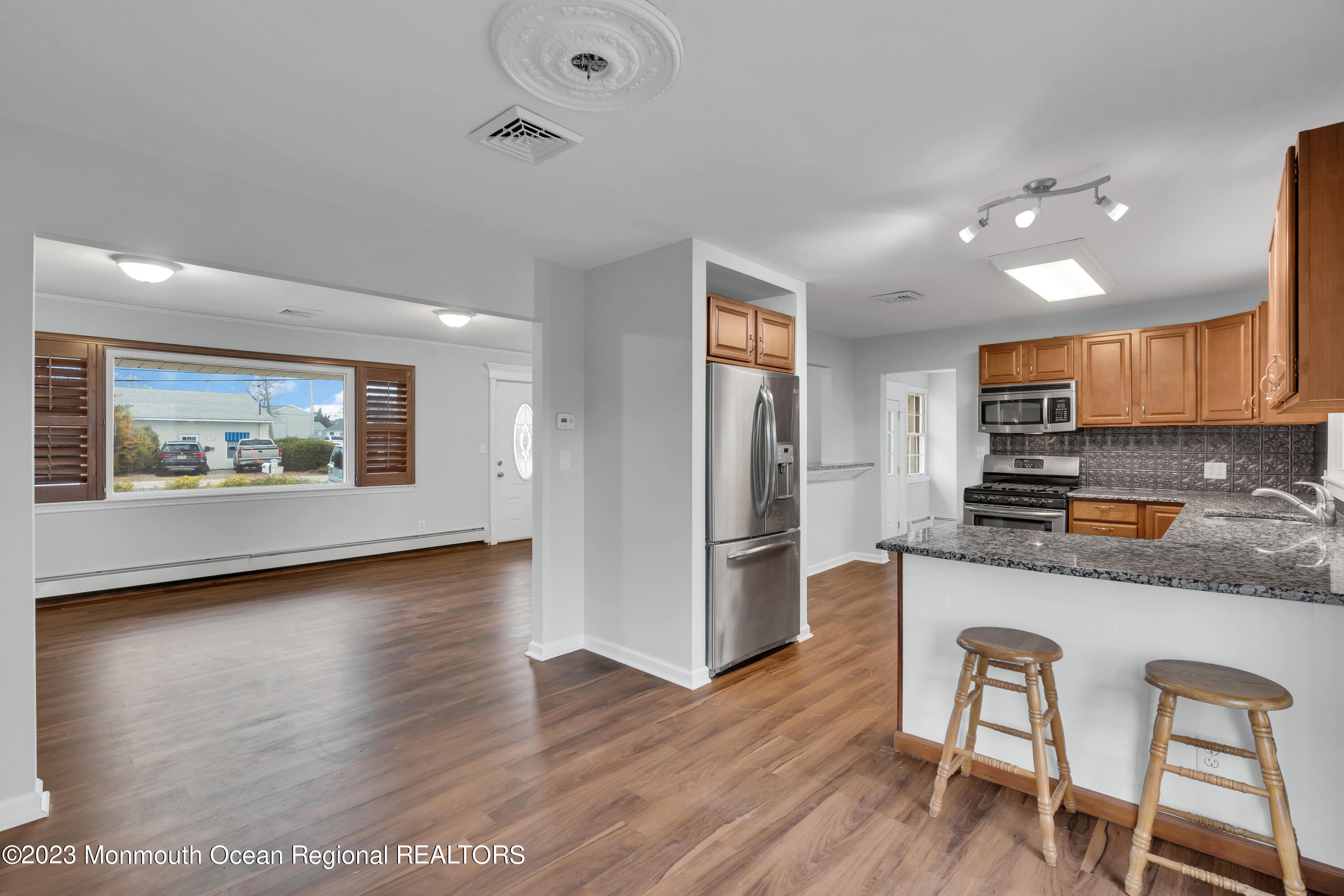 1007 Beaver Dam Road Point Pleasant, NJ 08742 - Photo 14 of 45 a kitchen with granite countertop wooden floor and stainless steel appliances