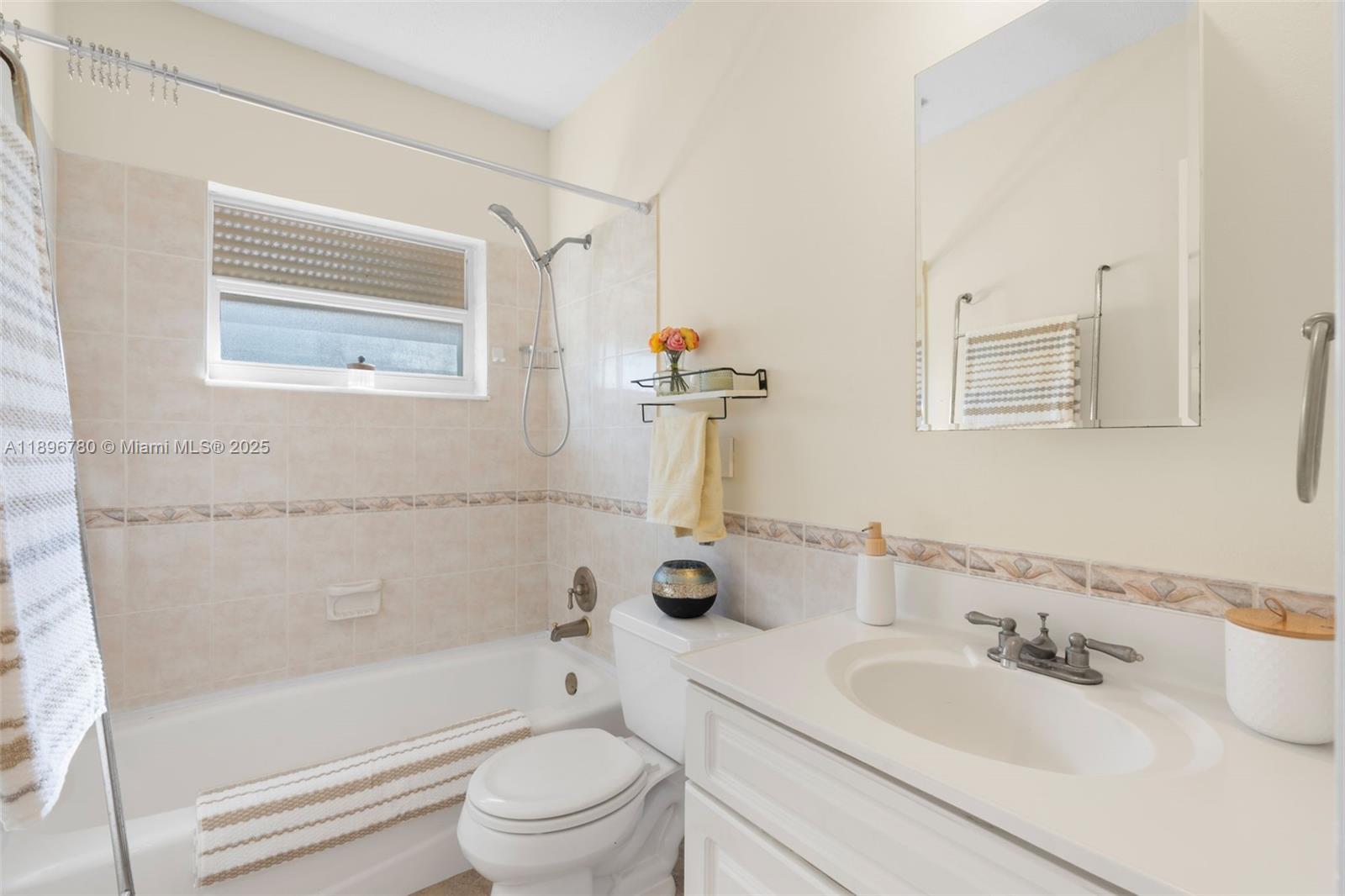 7305 Northwest 95th Way Tamarac, FL 33321 - Photo 15 of 24 a bathroom with a sink a toilet and shower