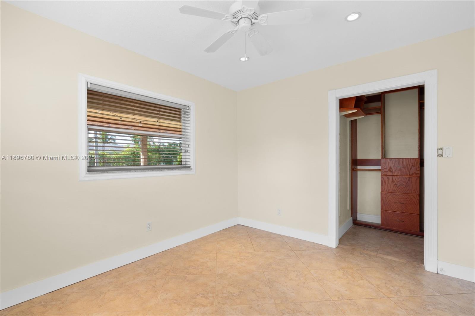 7305 Northwest 95th Way Tamarac, FL 33321 - Photo 16 of 24 an empty room with a window and a kitchen