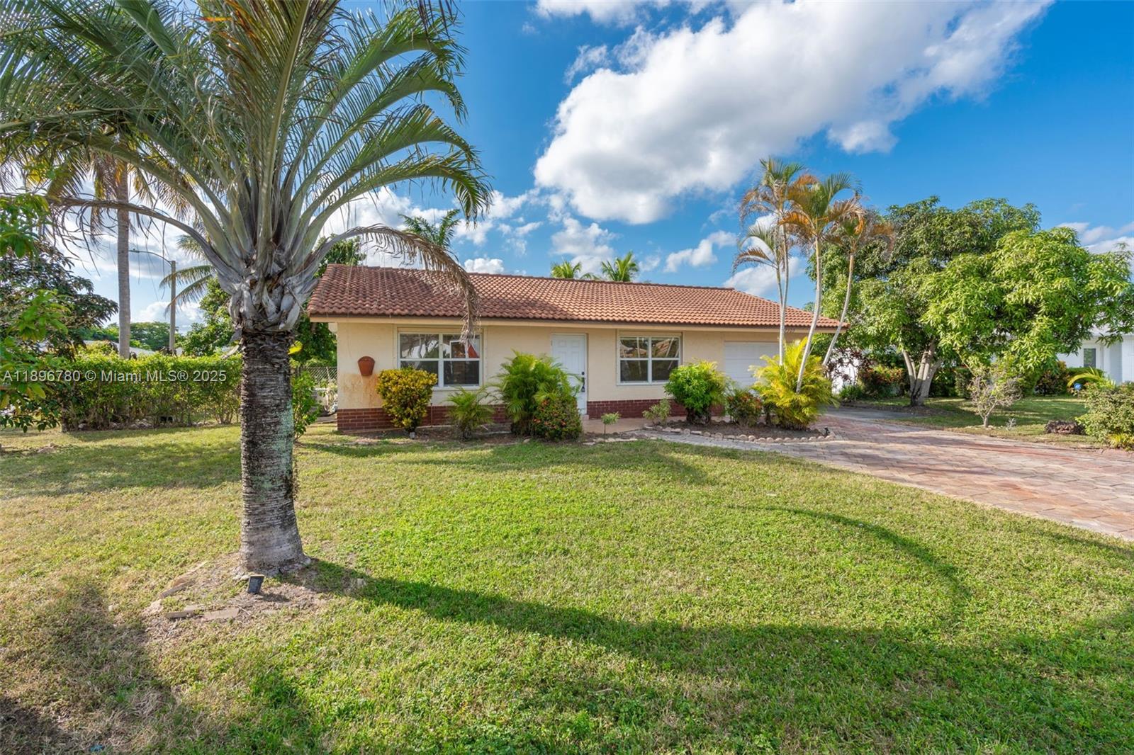 7305 Northwest 95th Way Tamarac, FL 33321 - Photo 17 of 24 a front view of a house with garden