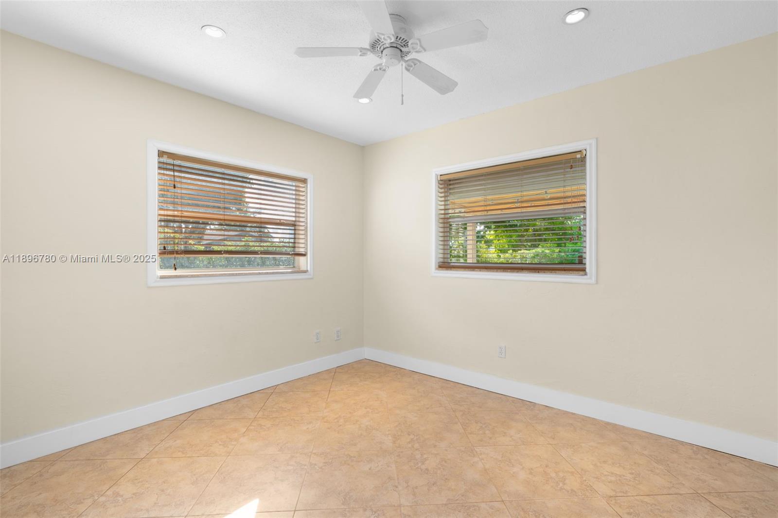 7305 Northwest 95th Way Tamarac, FL 33321 - Photo 18 of 24 an empty room with a window and a ceiling fan