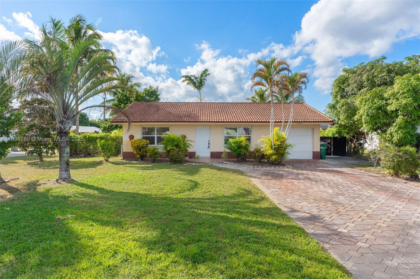 7305 Northwest 95th Way Tamarac, FL 33321 - Photo 19 of 24 a front view of a house with garden