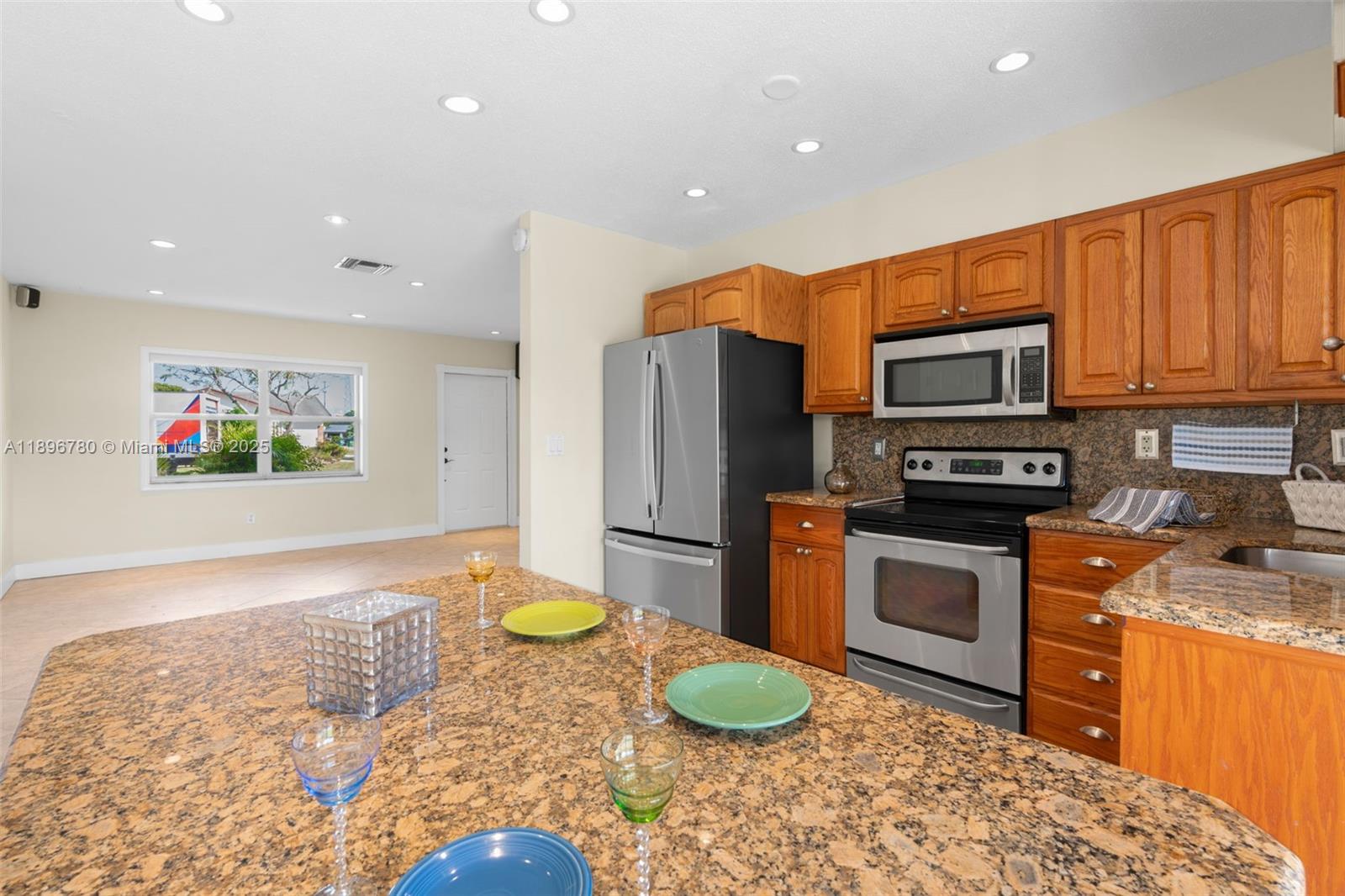 7305 Northwest 95th Way Tamarac, FL 33321 - Photo 3 of 24 a kitchen with stainless steel appliances granite countertop a refrigerator a stove top oven and a sink