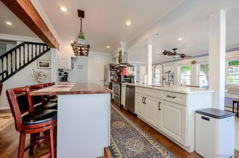 a kitchen with cabinets and chairs