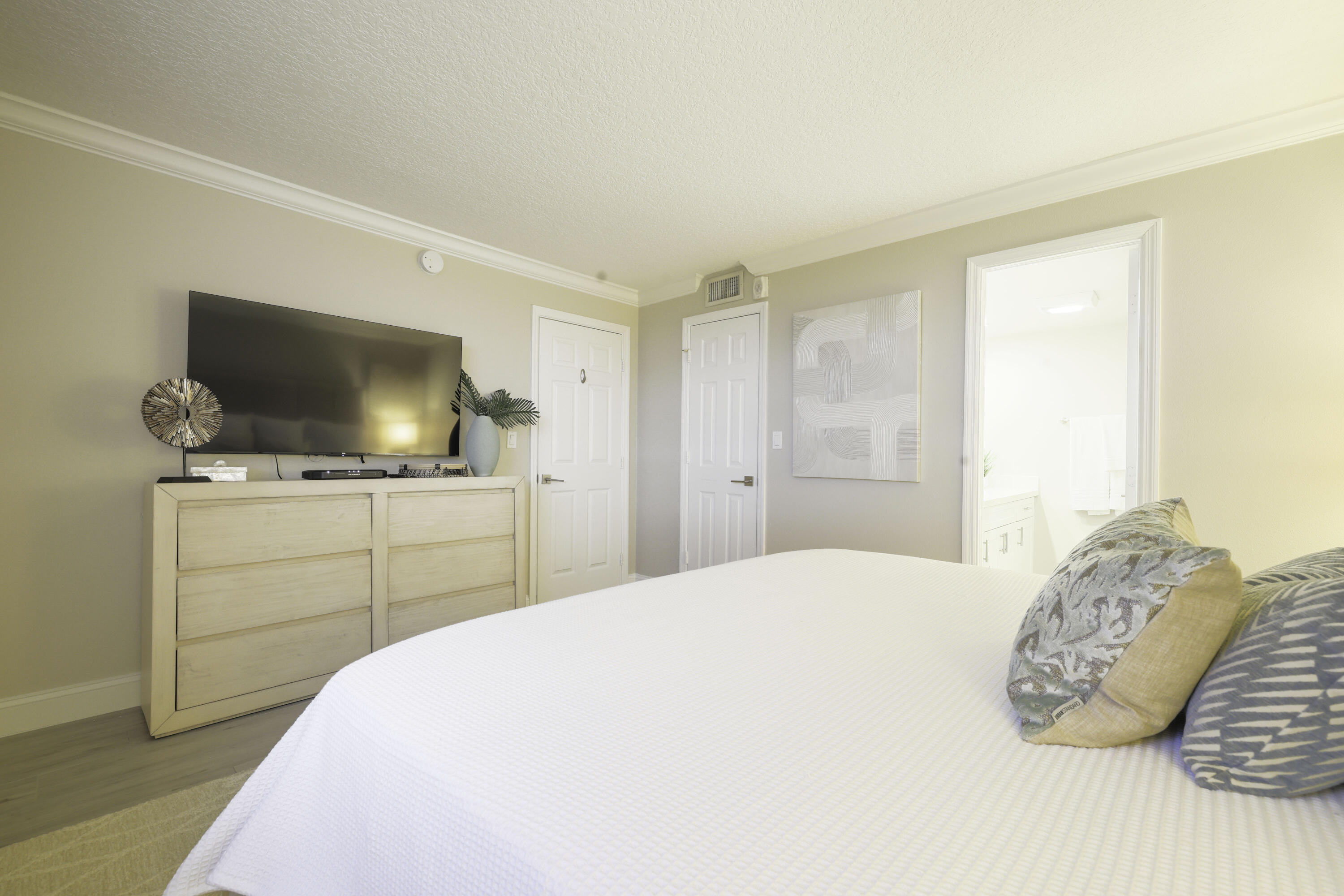 601 North Ocean Boulevard Boca Raton, FL 33432 - Photo 18 of 36 a bedroom with a bed and a flat screen tv