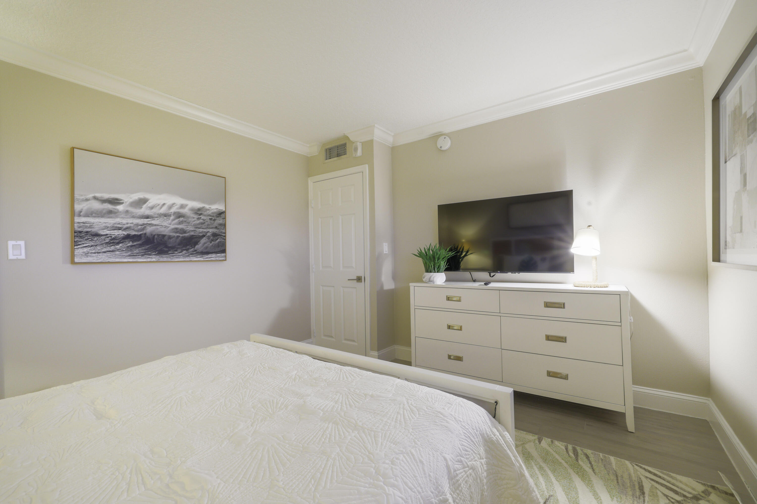 601 North Ocean Boulevard Boca Raton, FL 33432 - Photo 21 of 36 a bedroom with a bed and a flat screen tv