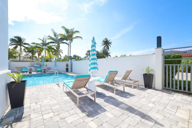 a view of swimming pool with outdoor seating and plants
