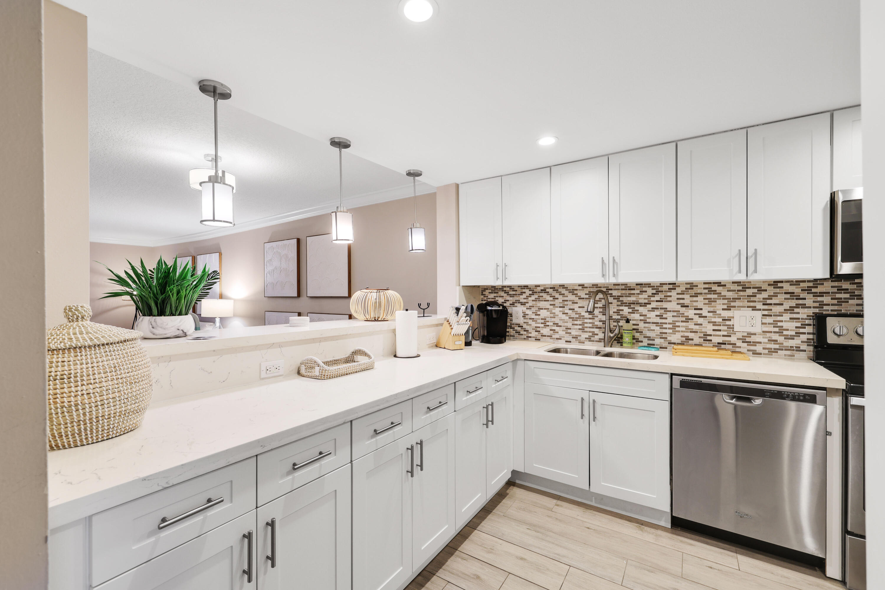 601 North Ocean Boulevard Boca Raton, FL 33432 - Photo 5 of 36 a kitchen with white cabinets sink and white appliances