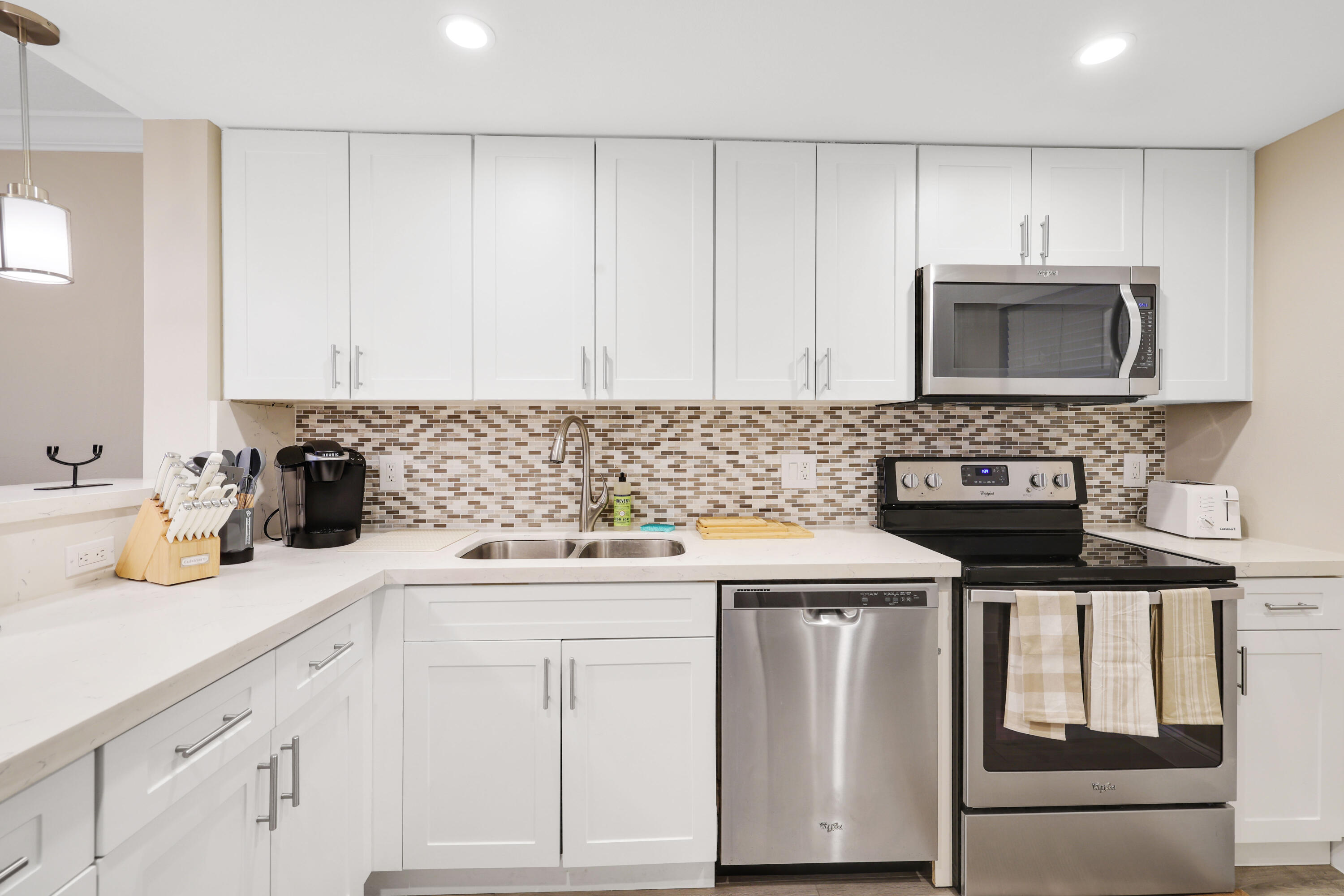 601 North Ocean Boulevard Boca Raton, FL 33432 - Photo 7 of 36 a kitchen with cabinets appliances and a sink