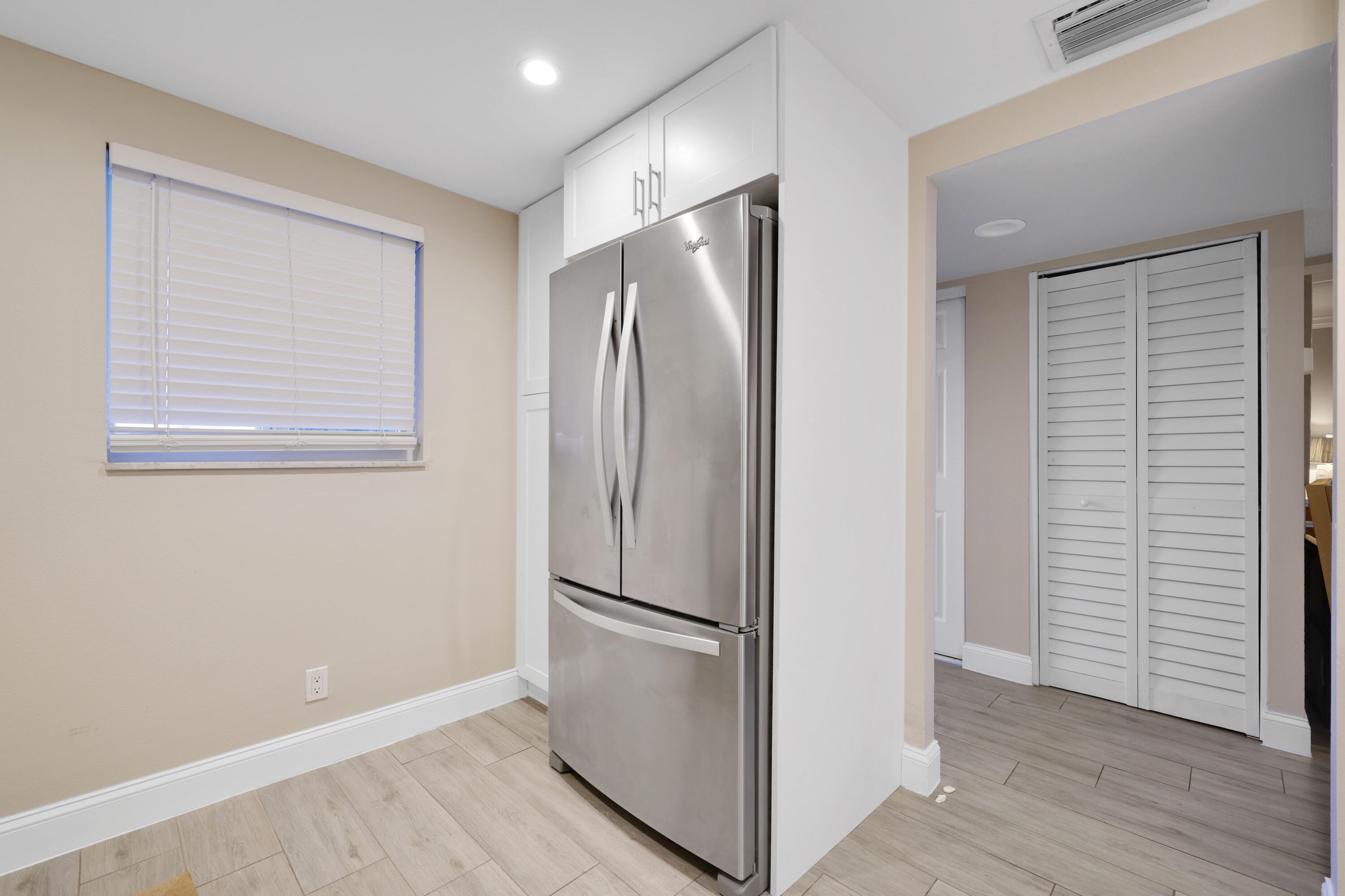 601 North Ocean Boulevard Boca Raton, FL 33432 - Photo 8 of 36 a view of a refrigerator in kitchen and wooden floor