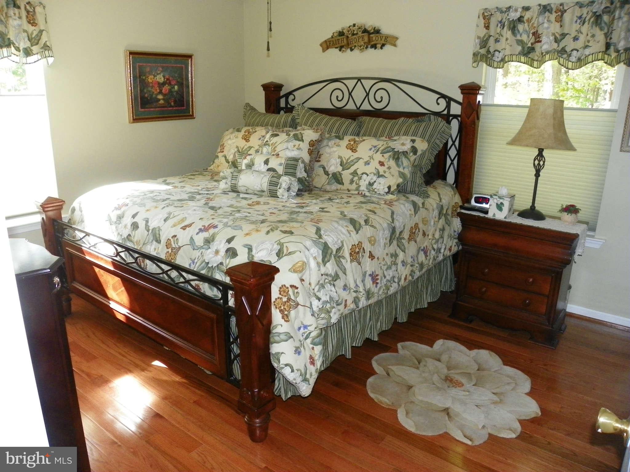 1130 Calvert Beach Road St. Leonard, MD 20685 - Photo 11 of 21 a bed sitting in a bedroom next to a window
