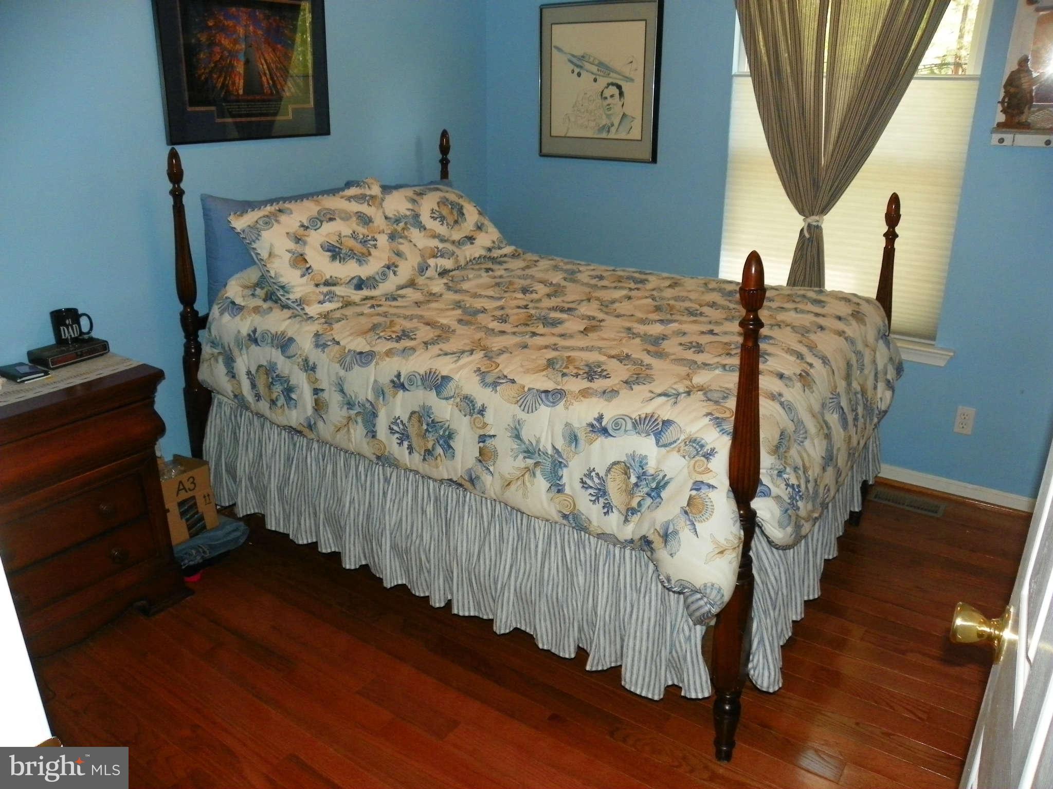 1130 Calvert Beach Road St. Leonard, MD 20685 - Photo 15 of 21 a bedroom with a bed dresser and a window