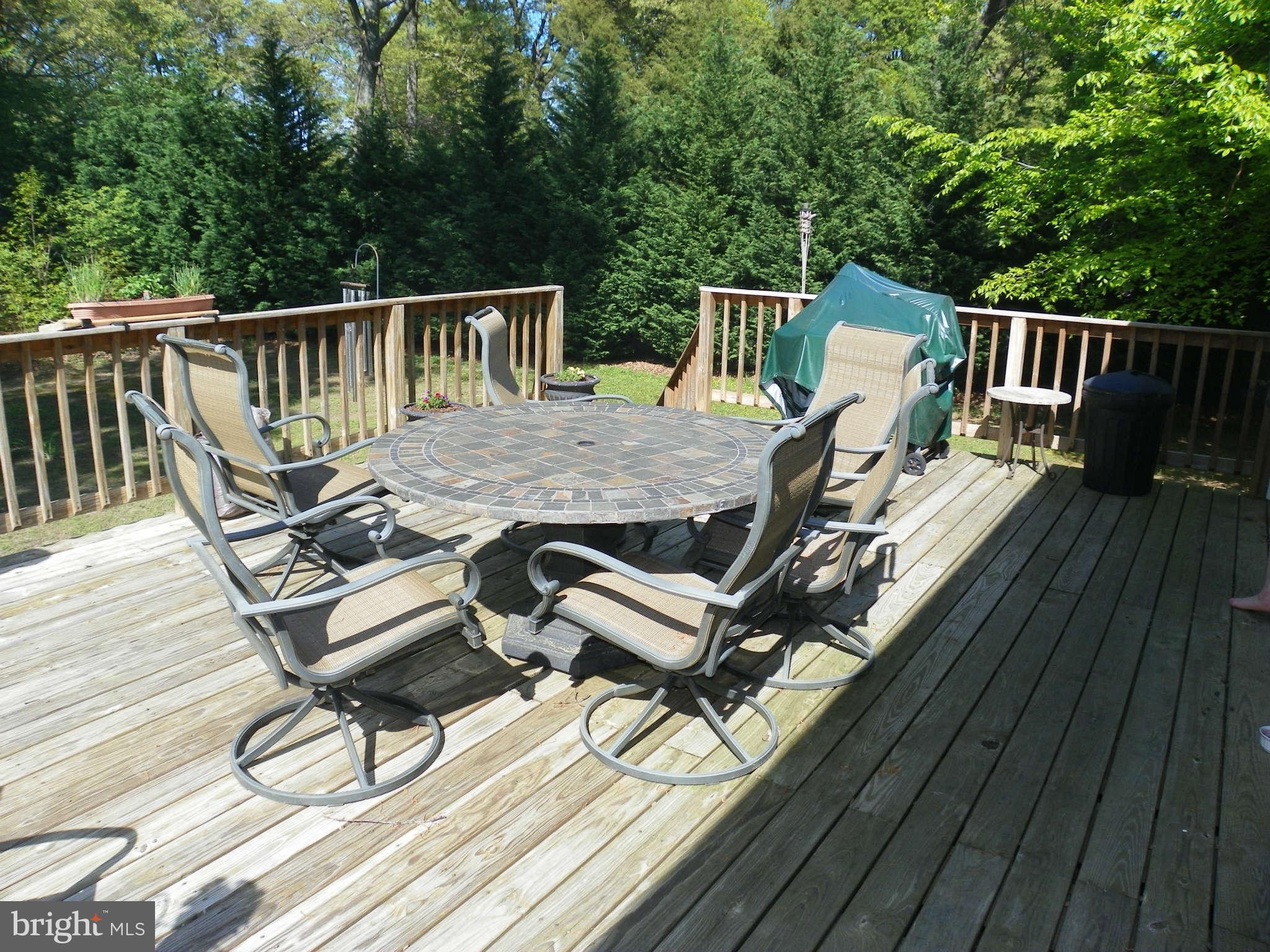 1130 Calvert Beach Road St. Leonard, MD 20685 - Photo 18 of 21 a view of balcony with wooden floor and outdoor seating