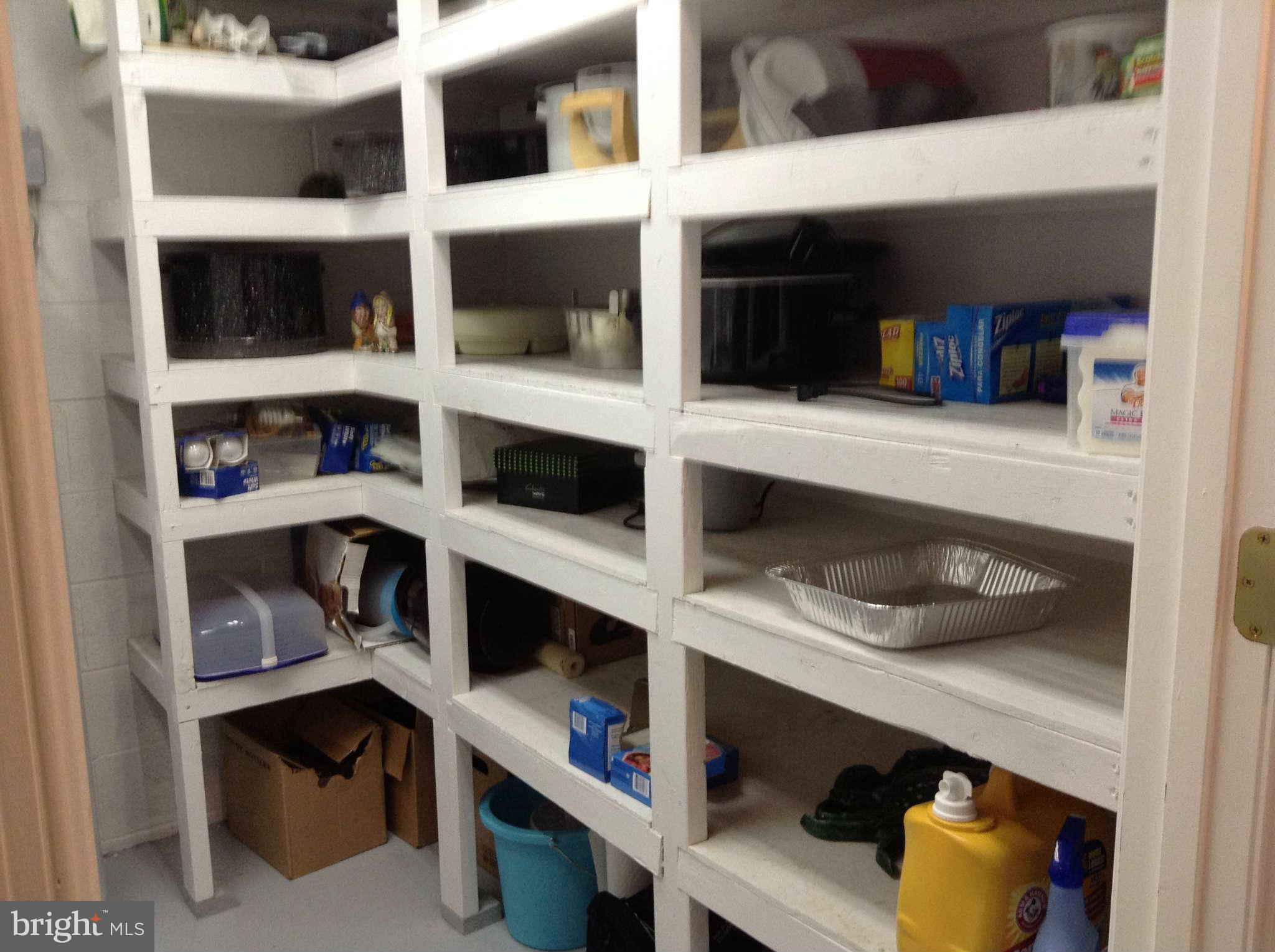 1130 Calvert Beach Road St. Leonard, MD 20685 - Photo 20 of 21 a shelf with books and knick knacks on it