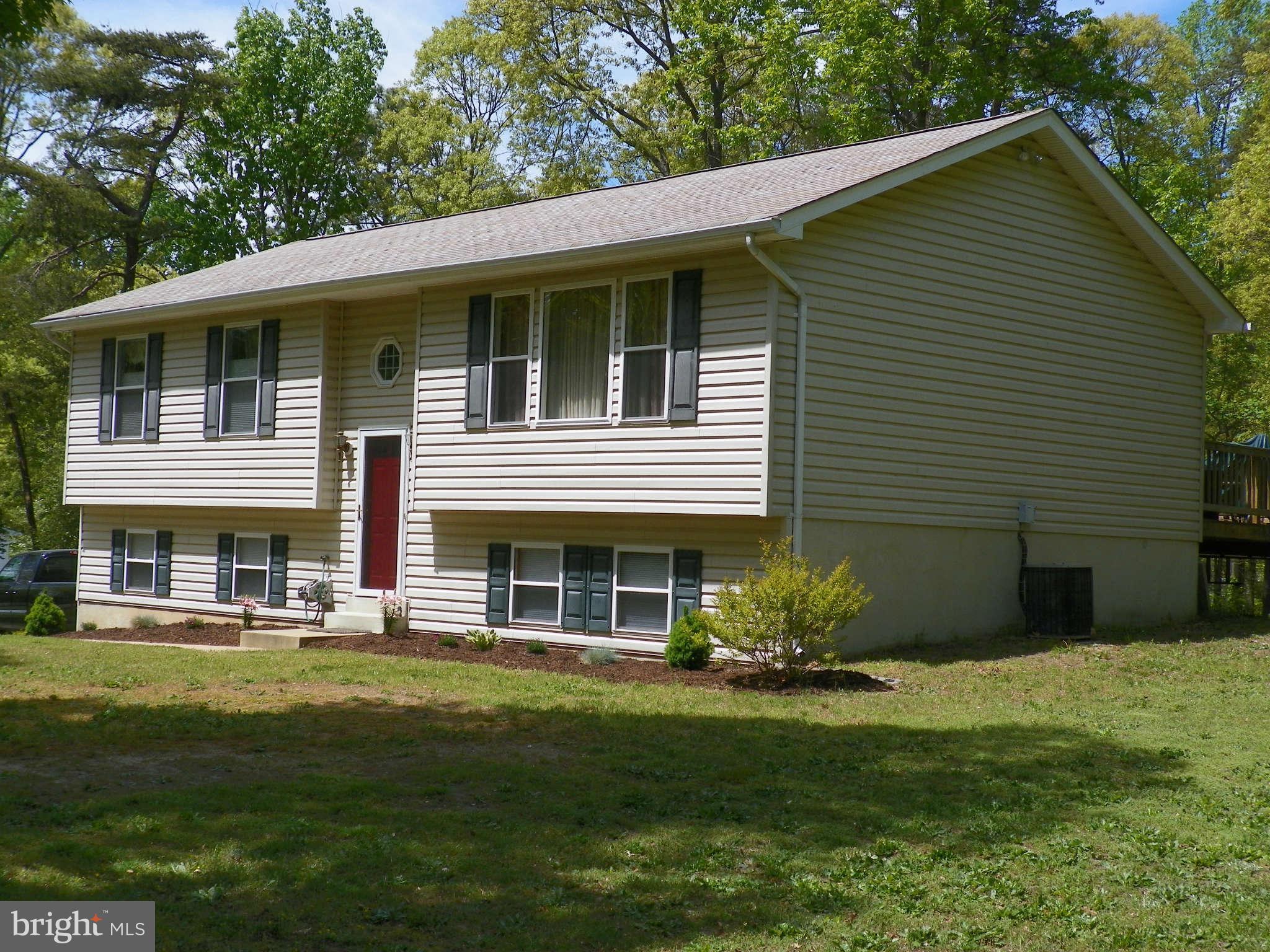 1130 Calvert Beach Road St. Leonard, MD 20685 - Photo 3 of 21 a front view of a house with garden