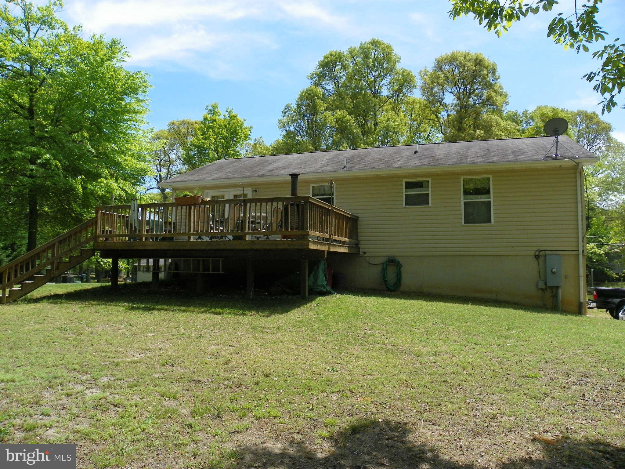 1130 Calvert Beach Road St. Leonard, MD 20685 - Photo 5 of 21 a backyard of a house with yard and trampoline