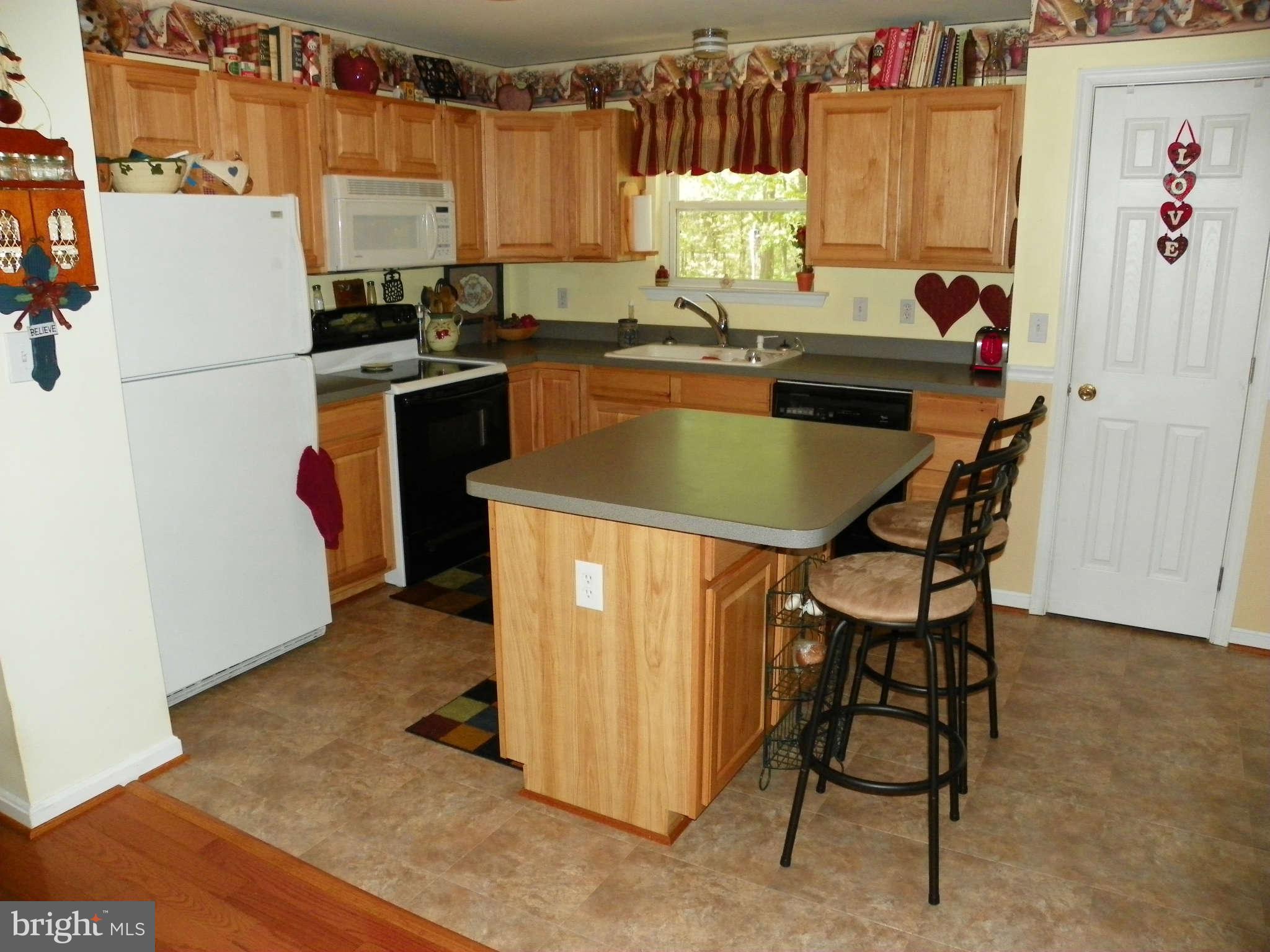 1130 Calvert Beach Road St. Leonard, MD 20685 - Photo 8 of 21 a kitchen with stainless steel appliances granite countertop a refrigerator and a stove