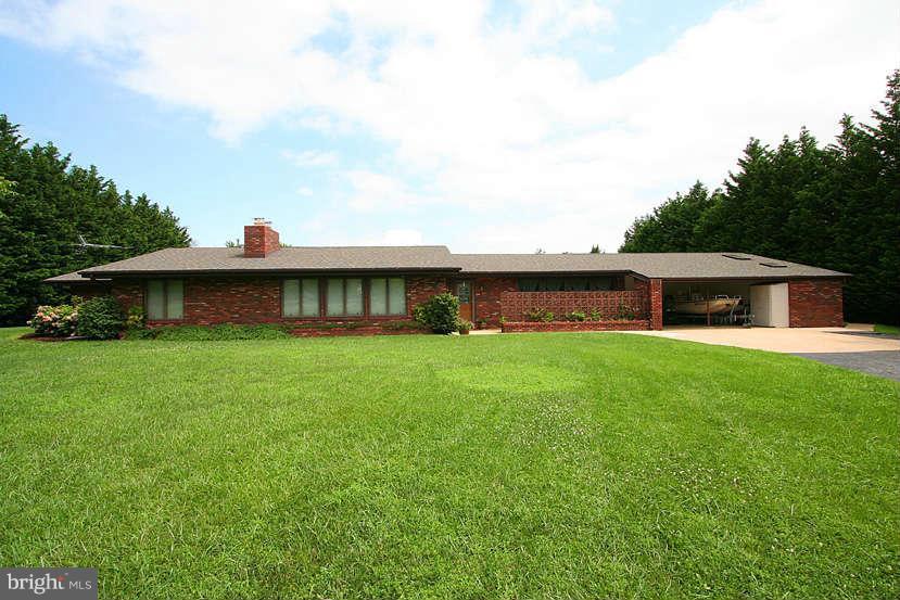 605 Old Point Road Chester, MD 21619 - Photo 2 of 30 a front view of a house with a yard and a garage