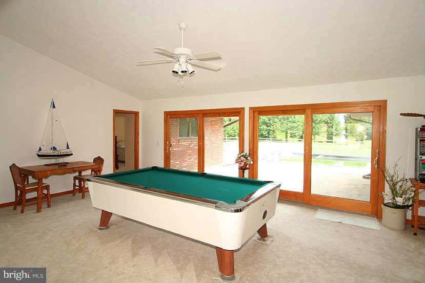 605 Old Point Road Chester, MD 21619 - Photo 13 of 30 a living room with a table chairs and a chandelier
