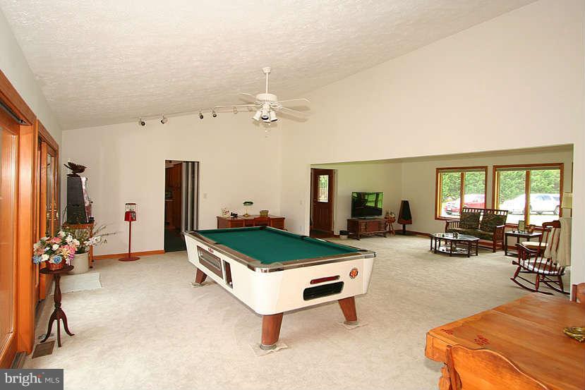 605 Old Point Road Chester, MD 21619 - Photo 14 of 30 a living room with furniture a window and gym equipment