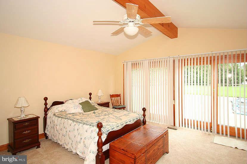 605 Old Point Road Chester, MD 21619 - Photo 15 of 30 a bedroom with a bed and a chandelier