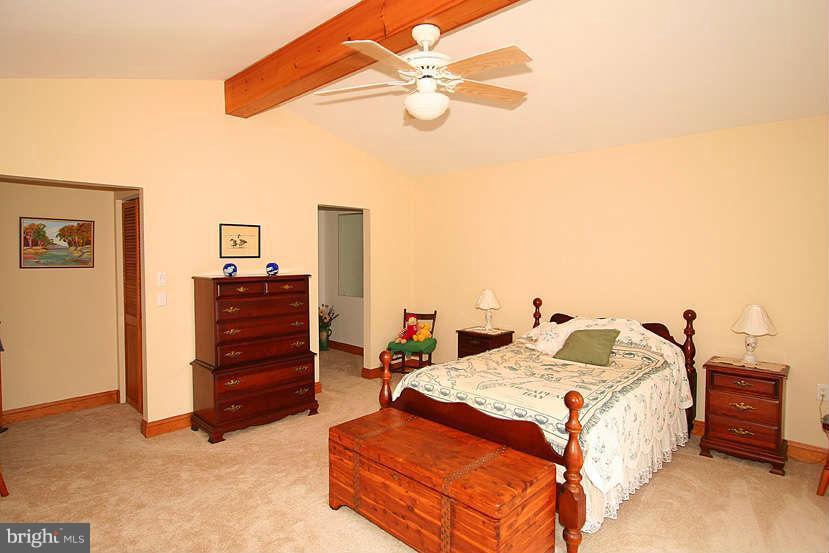 605 Old Point Road Chester, MD 21619 - Photo 16 of 30 a bed room with a bed and a chandelier