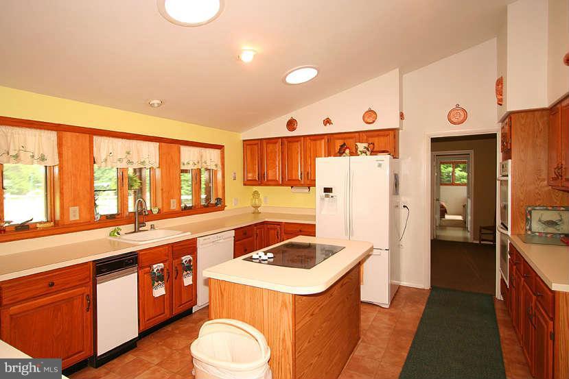 605 Old Point Road Chester, MD 21619 - Photo 18 of 30 a kitchen with a sink stove and refrigerator