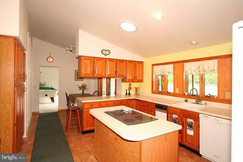 605 Old Point Road Chester, MD 21619 - Photo 19 of 30 a kitchen with a stove a sink and a refrigerator