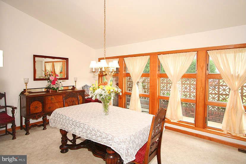 605 Old Point Road Chester, MD 21619 - Photo 21 of 30 a dining room with furniture and a floor to ceiling window