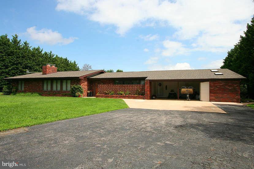 605 Old Point Road Chester, MD 21619 - Photo 4 of 30 a front view of a house with a yard and garage