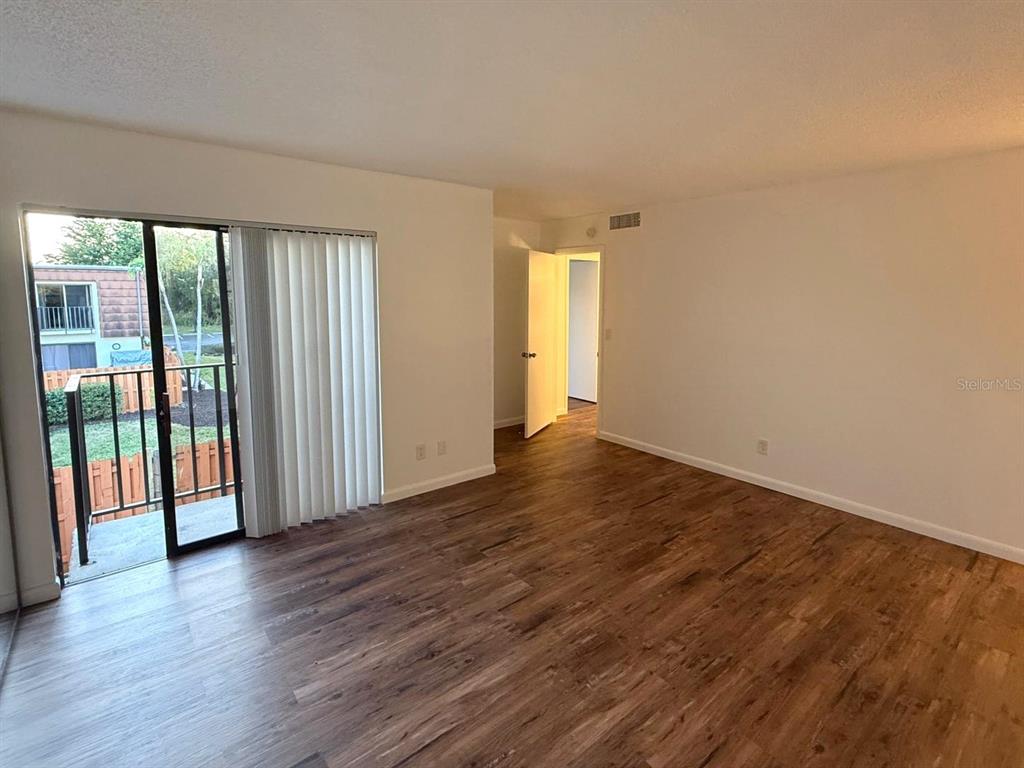 1406 Park Shore Circle, Unit 3 Fort Myers, FL 33901 - Photo 12 of 25 wooden floor in an empty room with a window