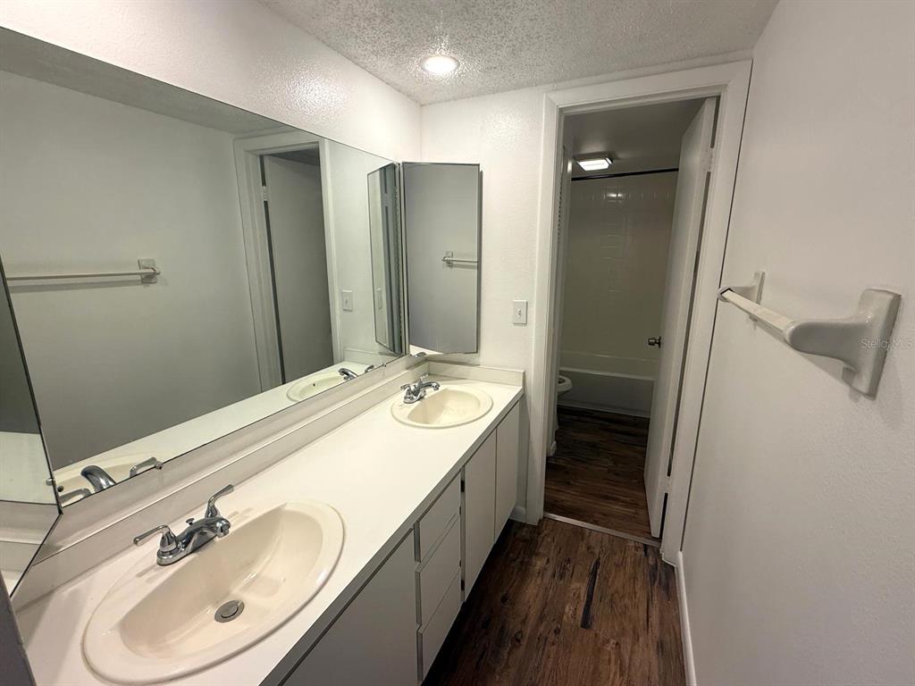 1406 Park Shore Circle, Unit 3 Fort Myers, FL 33901 - Photo 14 of 25 a bathroom with a double vanity sink and mirror