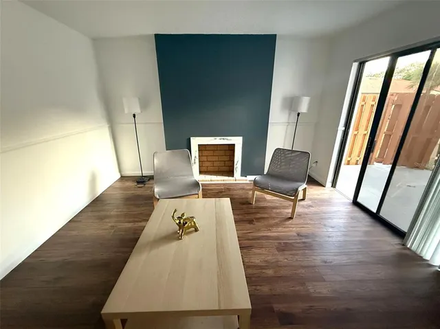 a living room with wooden floor and a table