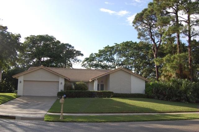 2899 Northwest 24th Court Boca Raton, FL 33431 - Photo 31 of 31 a front view of a house with a yard and garage