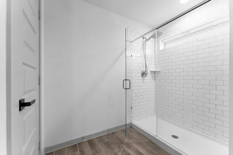 a bedroom with a bed chandelier and window