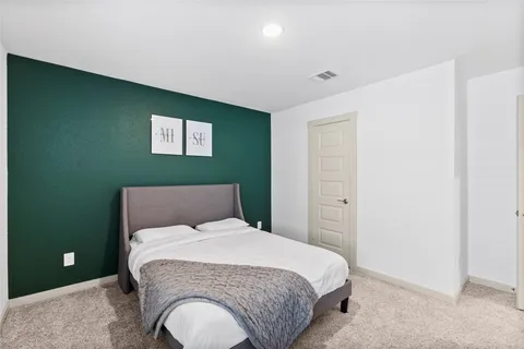 a bedroom with a bed and flowerpot