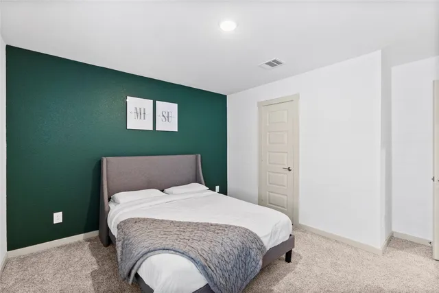 a bedroom with a bed and flowerpot