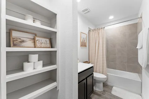 a bathroom with a toilet sink and shower